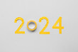 Figure 2024 made of adhesive tape on grey background