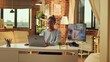 © DC Studio - Teleworker works at desk and concludes web based tasks while the sun is setting. Working remotely from home, running personal website and delivering correspondence. Developer multitasking.