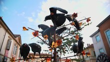 Art Installation In The City. Birds Perched On A Tree In The Square. The Tree Adorned With Flowers In The Park.