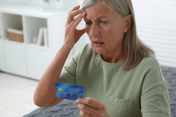 Canvas Print - Upset woman with credit card became fraud victim indoors