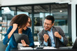 © NanSan - Asian business man and African American woman engaging in business discussion, possibly about merger or joint venture. two companies become one, one of companies often survives while other disappears