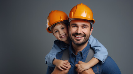 Wall Mural - father is giving a piggyback ride to his delighted young child who is wearing a safety hard hat.