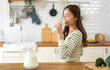 © Art_Photo - Portrait of beauty healthy asian woman smiling and having protein breakfast drinking and hold glasses of milk of fresh milk, nutrition,calcium and vitamin,dairy product in kitchen at home.Diet concept