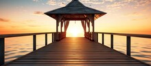 Wedding Gazebo On The Wooden Pier Into The Sea With The Sun At Sunset