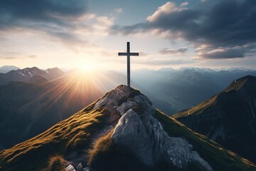 Wooden cross on the top of the mountain with clouds on the background