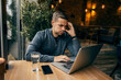 © Dusan Petkovic - An overworked freelancer is using his laptop in cafe.