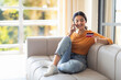 © Prostock-studio - Online Banking. Smiling Indian Woman Talking On Cellphone And Holding Credit Card