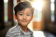 © Oliver Evans Studio - portrait of a boy of asian origin, smiling, cute child, indoors, in a house, bright sunny day, blurred background, happy, upbeat, intense look, positive, chinese, vietnamese, japanese