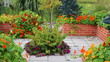 Summer background. A modern vegetable garden with raised bricks beds . Raised beds gardening in an urban garden
