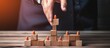 Hand placing a wooden cube stage for symbol job employee career position business concept