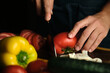 close-up of the cook's hands slicing tomatoes