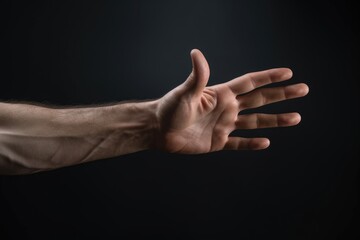 Wall Mural - A close-up image of a man's hand reaching out towards something. This versatile picture can be used to represent concepts such as assistance, help, support, connection, or curiosity.