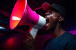 young man holding megaphone bokeh style background