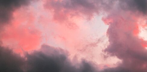 Pink sky with stormy clouds. Sunrise clouds are in vanilla colours. Beauty in nature. Details of evening sunset. Natural abstraction. Tension concept. Panoramic view. After thunderstorm