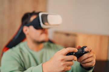 Gamer's hands using joystick and wearing virtual reality goggles