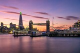 Fototapeta  - a beautiful sunset view of a large city over water in london