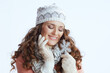 © Alliance - happy trendy woman in sweater, mittens, hat and scarf