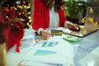 © Alliance - Business woman in green office with Christmas tree working