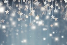 Glittering Silver Stars Suspended Against A Soft Blue Bokeh Background