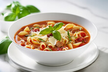 Pasta Fagioli Soup In A White Bowl With Fresh Herbs