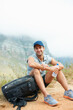 © Anne/peopleimages.com - Break, man or portrait in nature hiking with water, backpack or drink in workout, training or exercise mockup. Happy, smile or relax person on mountains trail health, wellness or summer sports rest