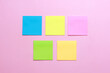 © Gatot - Blank multicolor sticky notes on pink background.