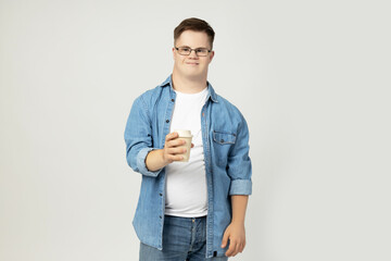 Wall Mural - PNG,smiling young man with down syndrome wearing glasses with a cup of coffee in his hand,isolated on white background