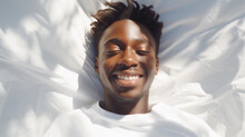 Black African American Man 20 Yo In A White Clothes Laying Down On White Bed With White Blanket, Happily Sleeping