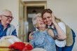 © Westend61 - Happy senior woman embracing healthcare worker at home