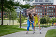 © Westend61 - Mother teaches her daughter to roller skate in the city