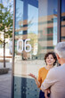 © Westend61 - Smiling businesswoman talking to senior colleague near glass wall