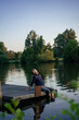 © Westend61 - Man sitting on jetty near lake at sunset