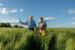 © Westend61 - Elderly couple having fun with grandson in field