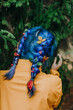 © Westend61 - Woman with dyed and braided hair near tree in forest