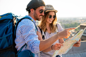 Wall Mural - happy couple on vacation sightseeing city with map. people travel fun honeymoon concept.