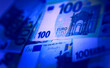Euro banknotes texture, concept of bank, taxes, income, successful business. 100 euro bills on with blue light.