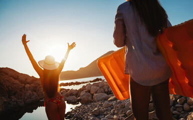 Wall Mural - Young beautiful girl on the beach at sunset