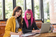 © Charlie's - LGBTQ+ transgender man Beautiful Authentic Specialist with Pink Hair and Non-binary trans working together Working Design in creative workplace team work colleagues Gender equality
