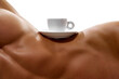 Body part portrait. White cup of coffee stands on naked female body with perfect body shapes, on waist against white background. Concept of glamour, drinks.