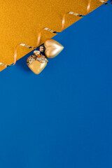 Wall Mural - new year's card in blue and gold. christmas toys hearts and gold ribbon. flat lay with copy space. c