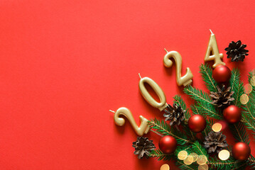 Wall Mural - red christmas background. top view photo of christmas tree branches and cones, red balls and bokeh l