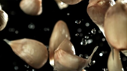 Poster - Garlic flies up with drops of water. Filmed on a high-speed camera at 1000 fps. High quality FullHD footage