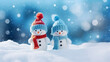 © Prasanth - little knitted snowmans on soft snow on blue background