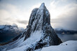 Aerial drone photo of snowy mountain hike up Segla in Senja, Norway.  Snowcapped mountains in the Arctic Circle of Northern Norway.  Famous hike on Senja island.  Shot in October