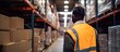 African supervisor examines cargo in warehouse with barcode scanner copy space image