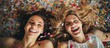 Bachelorette party with elated ladies having a great time together lying on bed upside down surrounded by confetti fun copy space image