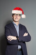 © artmim - Christmas man Santa standing on gray background, portrait