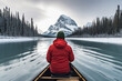 closed up of Male traveler in winter coat canoeing in Spirit Island on Maligne Lake at Jasper national park, AB, Canada