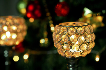 Composition with beautiful crystal candlesticks on x-mas tree background