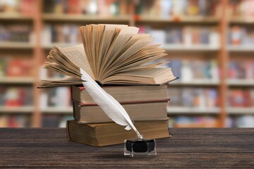 Wall Mural - Old books and retro quill pen in library.